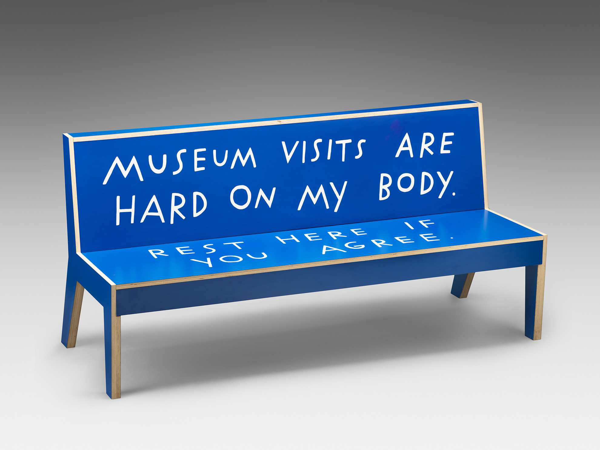 A blue bench written on with 