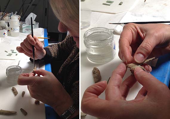 Close-up of conservation staff joining bone and bronze gragments by hand