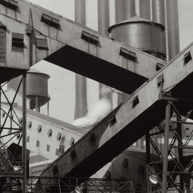 Detail of black-and-white-photograph of industrial factory emphasizing the geometric lines and shapes of the structures