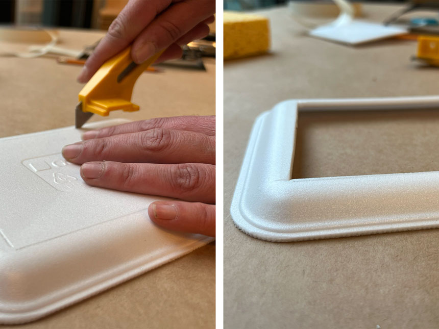 using box cutter to cut out base of styrofoam tray, leaving two inch border