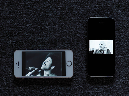 Two mobile phones with black-and-white photos on their screens.