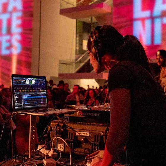 DJ working in booth during MFA Late Nites event in Shapiro Family Courtyard