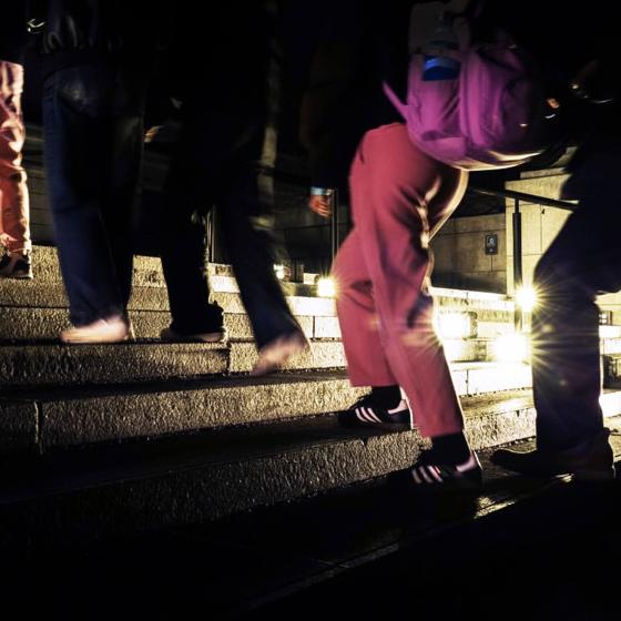 Close-up of legs of visitors walking up Huntington Avenue Entrance steps