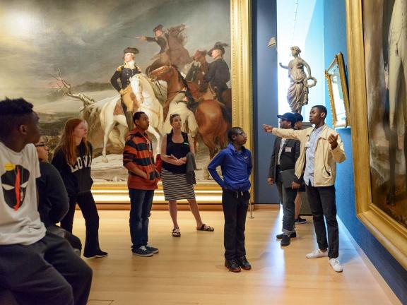 Students looking at paintings in New Nation gallery