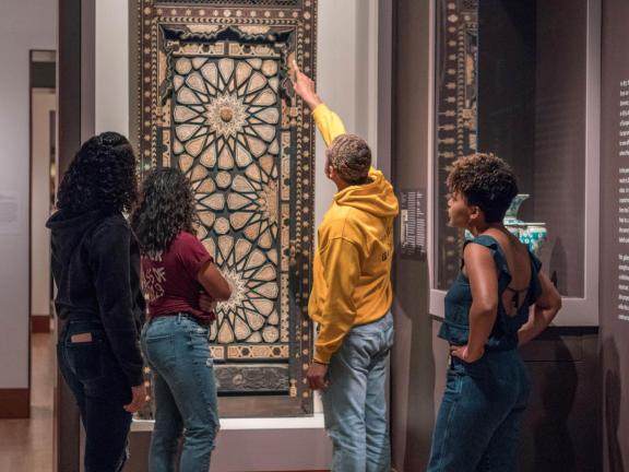 Students looking at minbar door in Islamic Art gallery