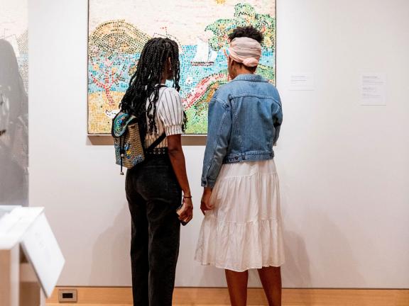 Two visitors looking at painting in an Art of the Americas gallery