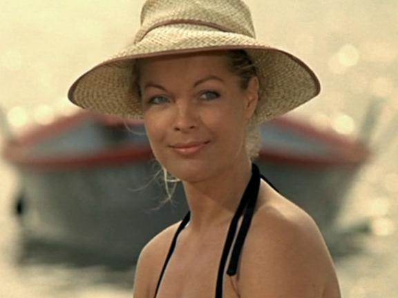 girl at the beach with a hat on