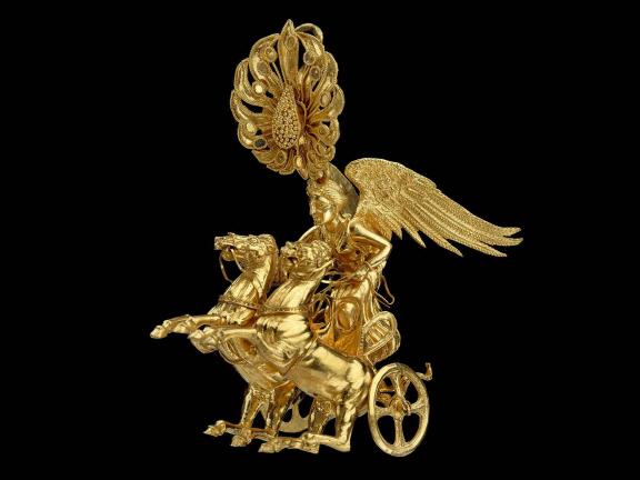 picture of a gold earring of Nike driving a two horse chariot