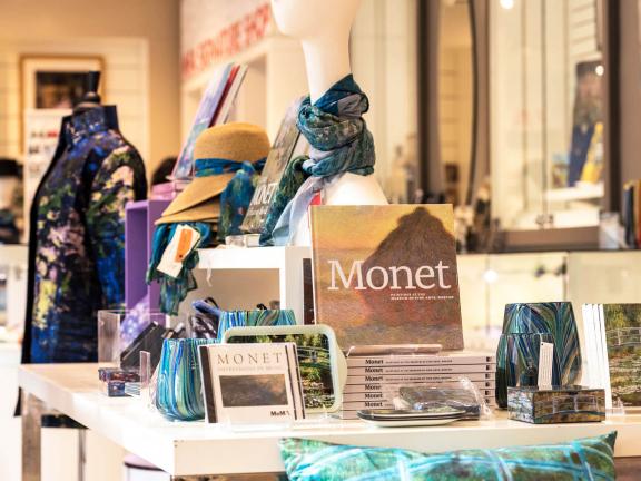 Display of Monet-related books and products on a table in the Museum shop