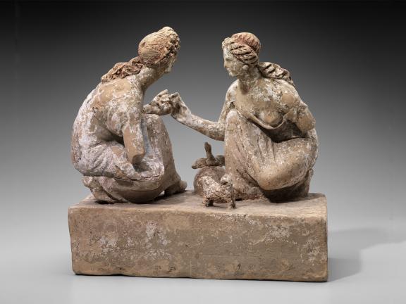 Terracotta sculpture of girls playing knucklebones game.