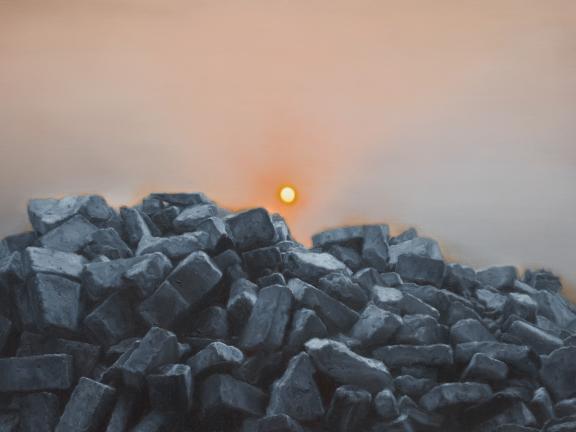 An orange sun rises in a smoggy sky over a pile of dark rubble.
