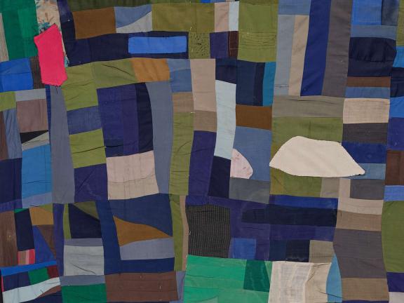Irregularly shaped scraps of fabric placed near each other to form an abstract colorful composition.