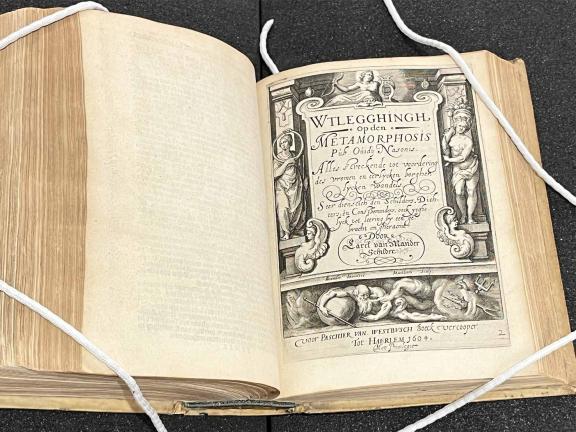 An old book open to an ornately decorated title page.