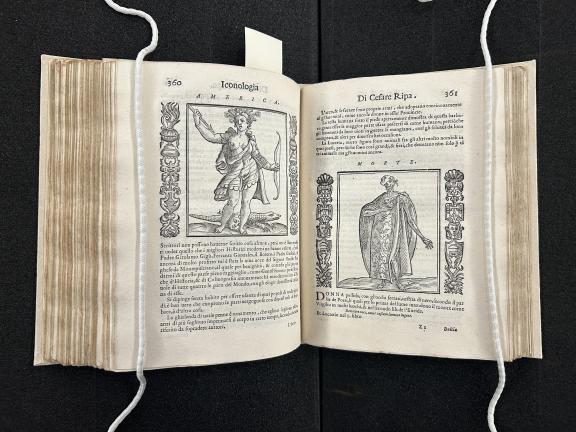 A book opened with verso showing text and an image of a woman ad recto showing text and an image of a man.