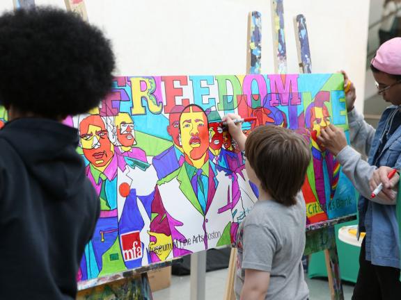Kids coloring mural of Martin Luther King, Jr. at MLK Day celebration