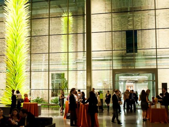 Wide view of attendees in formal evening attire mingling in Shapiro Family Courtyard
