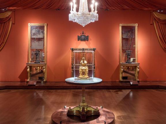 View of English Regency gallery, with round table in foreground and chandelier above