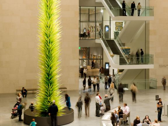 Visitors in Shapiro Family Courtyard around Chihuly's Lime Green Icicle Tower