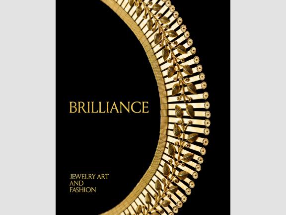 Image of book cover featuring a gold necklace with a floral design on a black background
