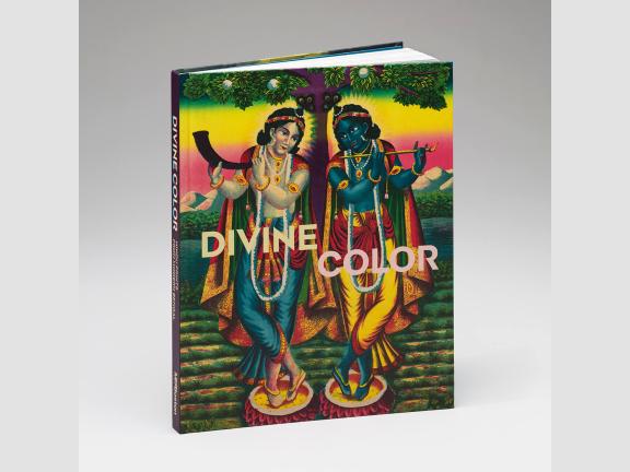 A brightly colored book cover shows two figures holding wind instruments and looking towards each other in symmetrical poses.  Both are adorned with colorful capes and jewels. They stand in front of a technicolor landscape.
