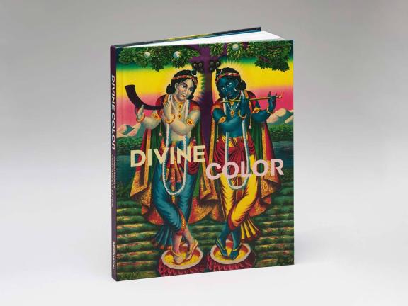 A brightly colored book cover shows two figures holding wind instruments and looking towards each other in symmetrical poses.  Both are adorned with colorful capes and jewels. They stand in front of a technicolor landscape.