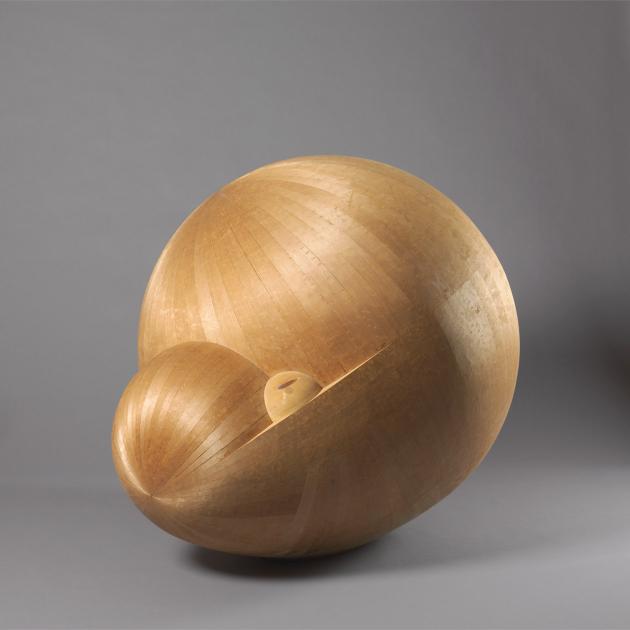A bulbous abstract figure that is a shimmering light brown.