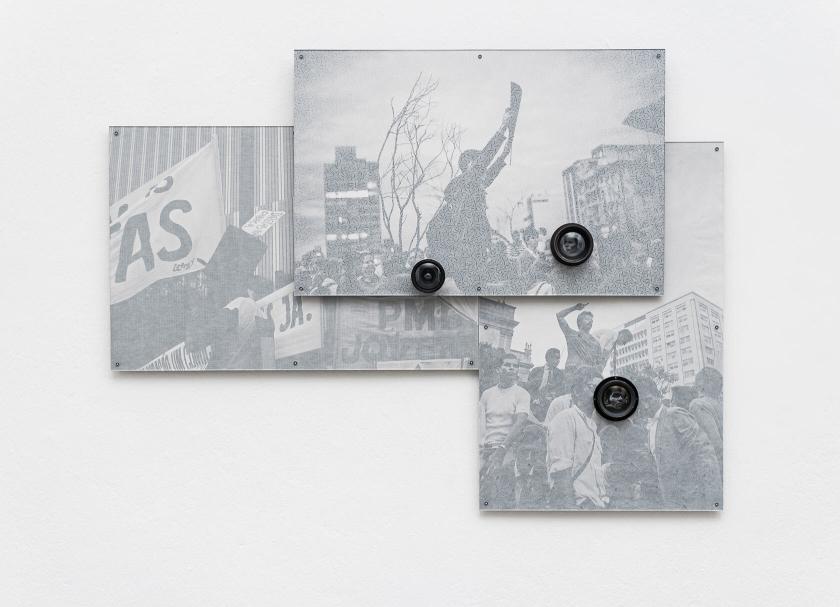 A grayscale photograph with old camera lenses mounted on top of it.