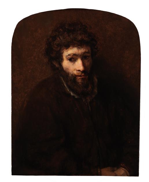 A young bearded man against a dark brown background.