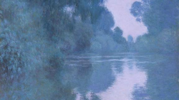 Detail of Monet painting, depicting river landscape with lush trees on both banks, all covered in purplish light