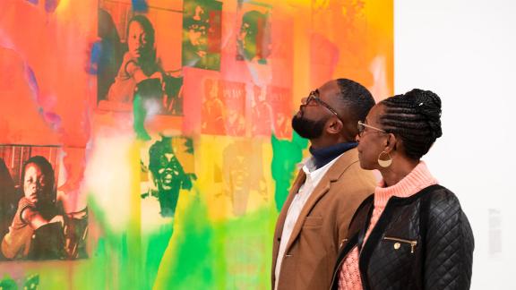 Two visitors look at Frank Bowling's "Middle Passage."