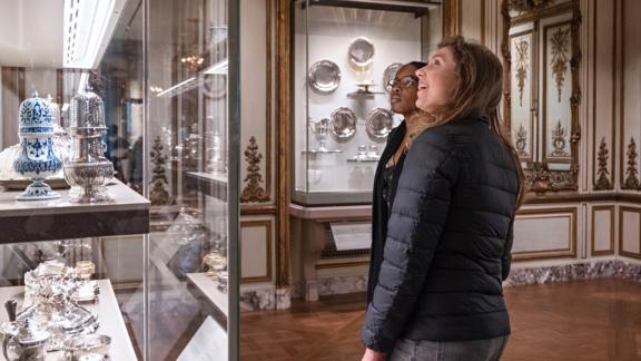 Two visitors explore the French Salon gallery.
