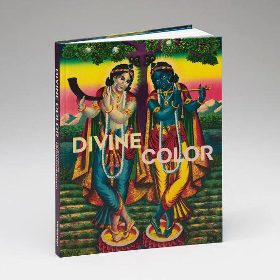 A brightly colored book cover shows two figures holding wind instruments and looking towards each other in symmetrical poses.  Both are adorned with colorful capes and jewels. They stand in front of a technicolor landscape.