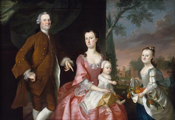 Before a pastoral garden landscape, a man in a powdered wig and brown coat stands beside a woman in a pink dress holding a baby and a young girl using her dress skirt to store citrus fruit.