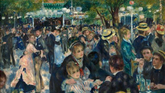A group of well-dressed people seated at tables and socializing over lunch in a lush shaded garden.