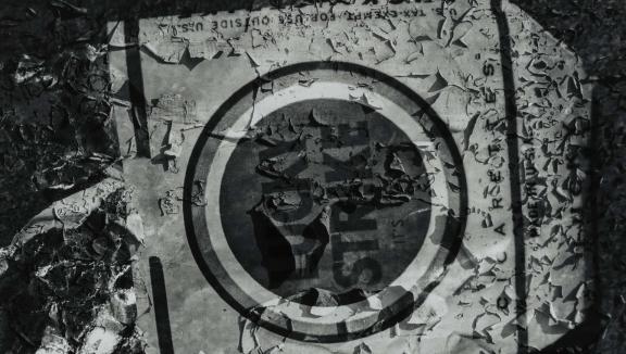 A decaying cardboard box of cigarettes with "LUCKY STRIKE" in bold graphic letters inside a circle.