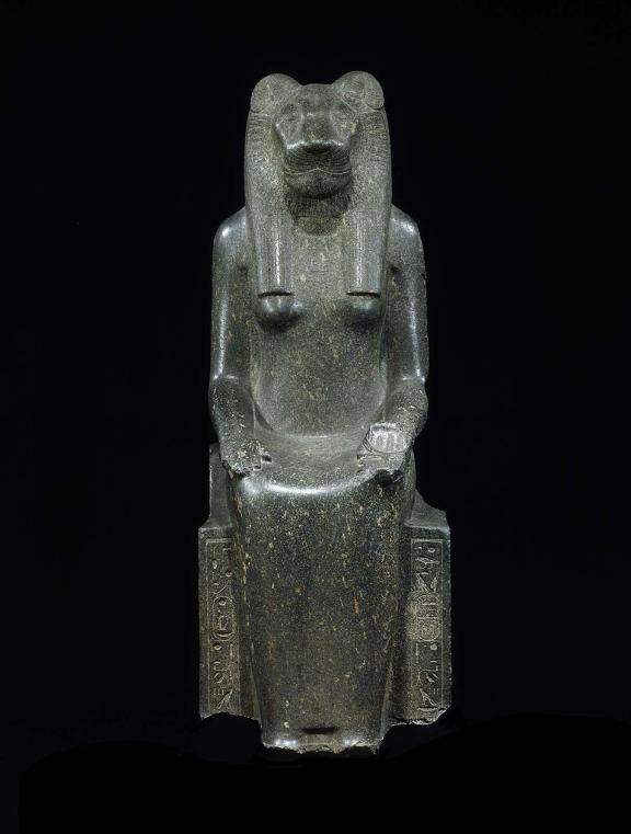 Statue of a seated human form with a lion's head.