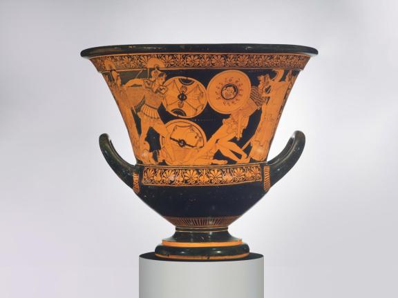 A black ceramic vessel with red-figure illustration of soldiers fighting in the Trojan War.