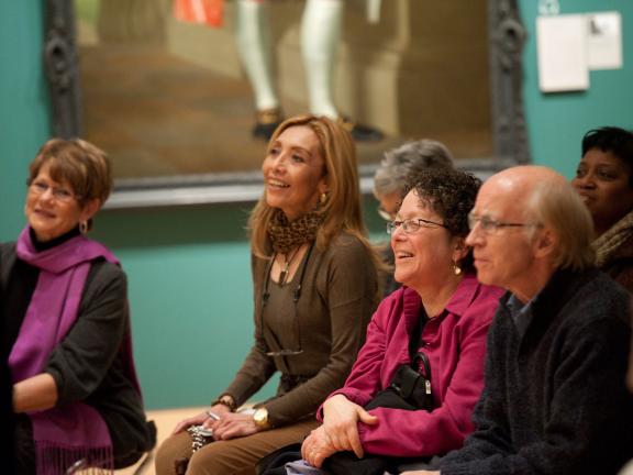 Visitors seated in Art of the Americas Wing gallery during gallery talk