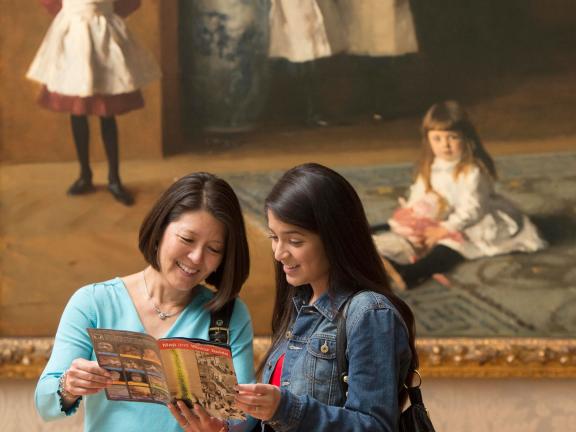Visitors looking at map in front of Boit Daughters painting
