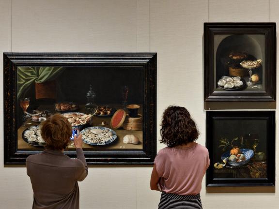 Visitors looking at Osias Beert's painting, Still Life with Various Vessels on a Table, in Gallery 243