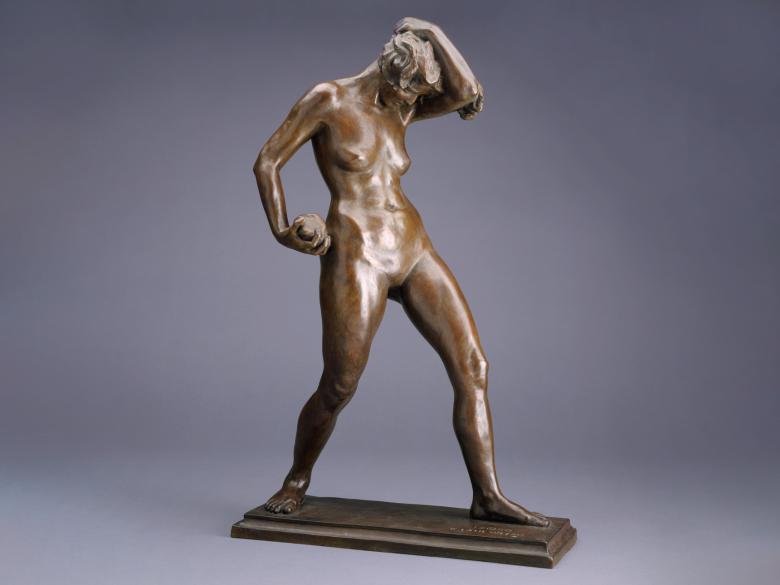 detail of bronze sculpture depicting woman with one arm touching top of head and the other holding stone