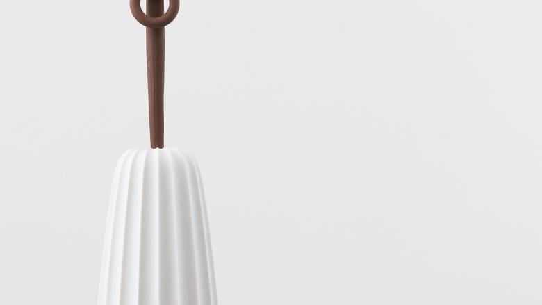 A tapered white column with a cast-iron rod sticking out of the top; the rod is ornamented at top with a shackle.