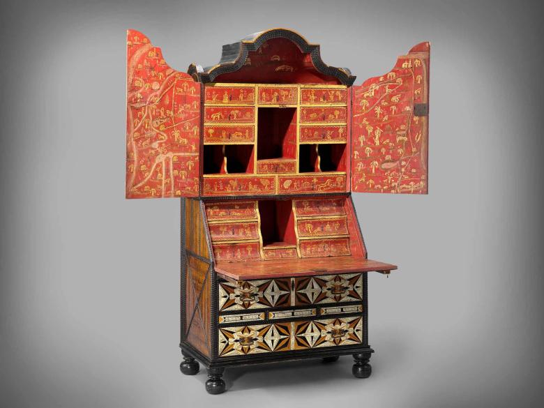 An elaborately decorated desk and bookcase with arabesque wooden inlays.