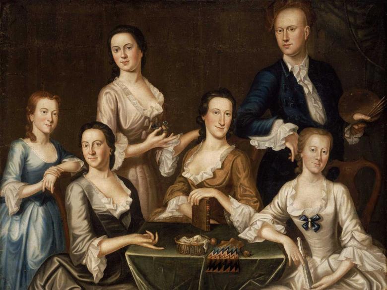 A family with an adult man and woman and children posing.