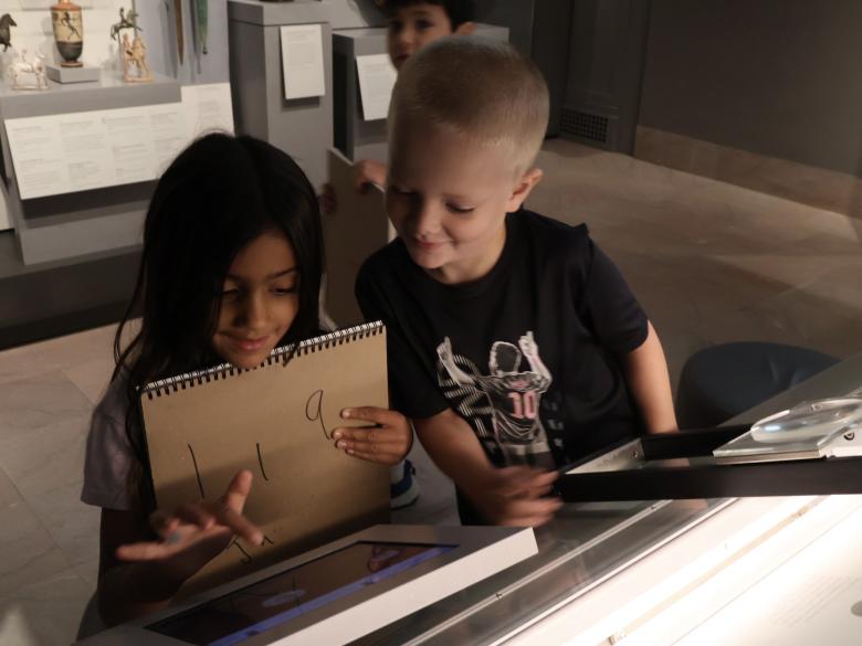 two young students look at display in galleries (SAC)