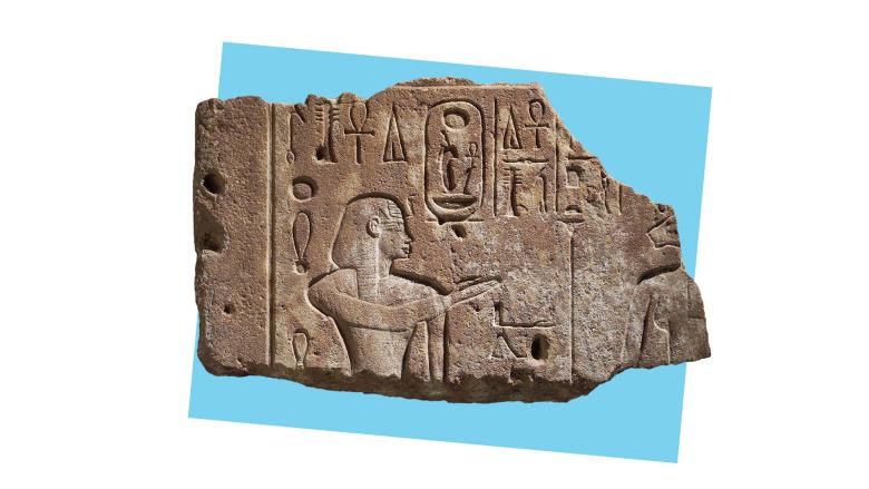Fragmented shard of a stone relief depicting two Egyptian pharaohs, in front of a blue square.