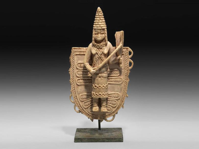 Ivory pendant of a queen in a headdress holding a baton